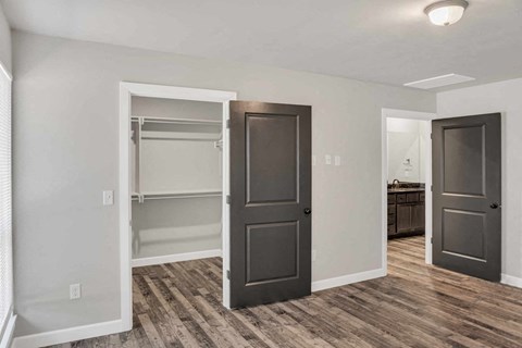a renovated living room with a closet and a door open