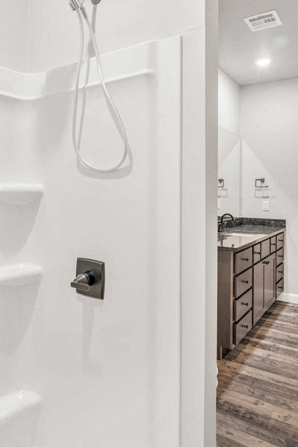 a bathroom with a toilet and a sink and a shower