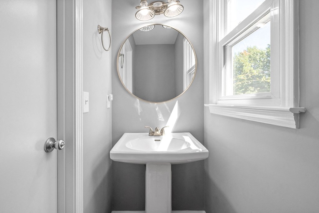 a small bathroom with a sink and a mirror