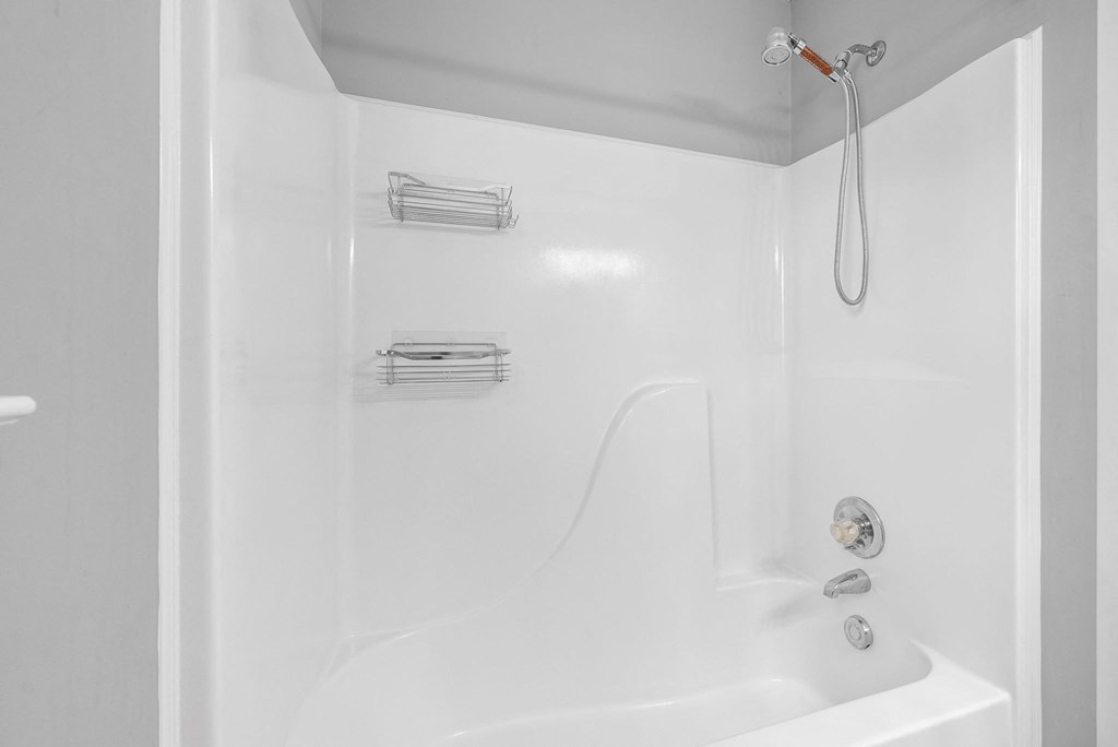 a white bathroom with a shower and a bath tub