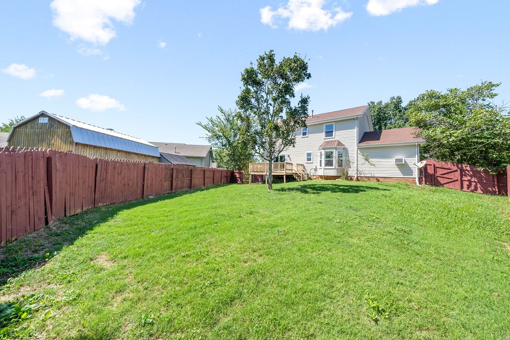 a backyard with a fence and a house