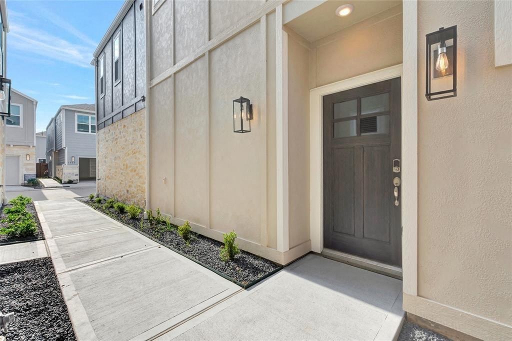 the front door of an apartment building with a sidewalk