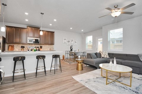 a living room with a kitchen and a couch