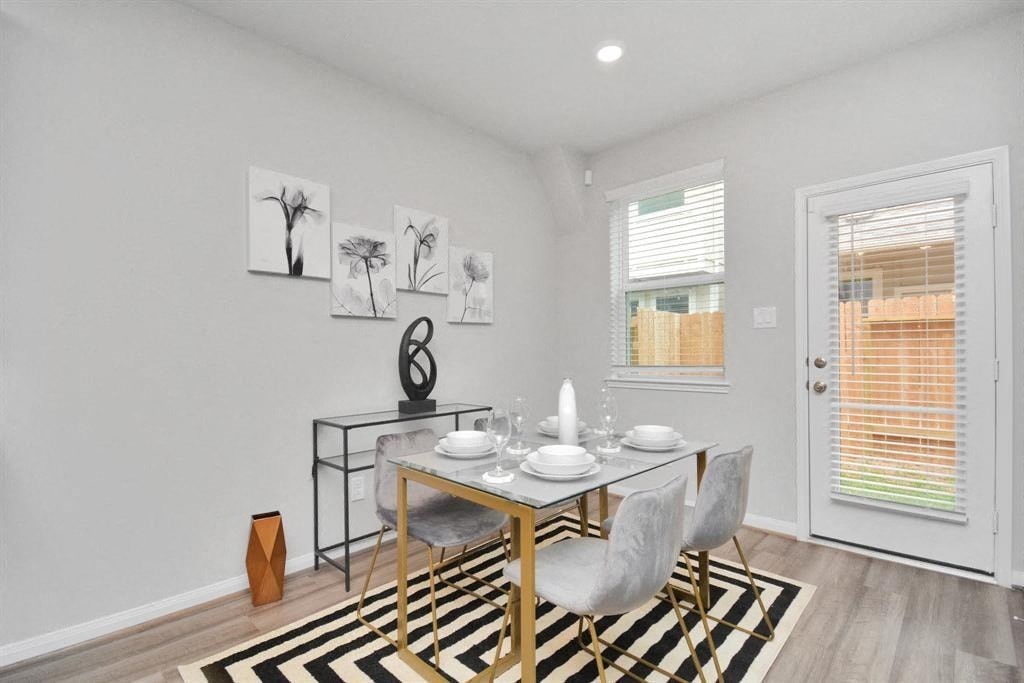 an image of a dining room with a table and chairs