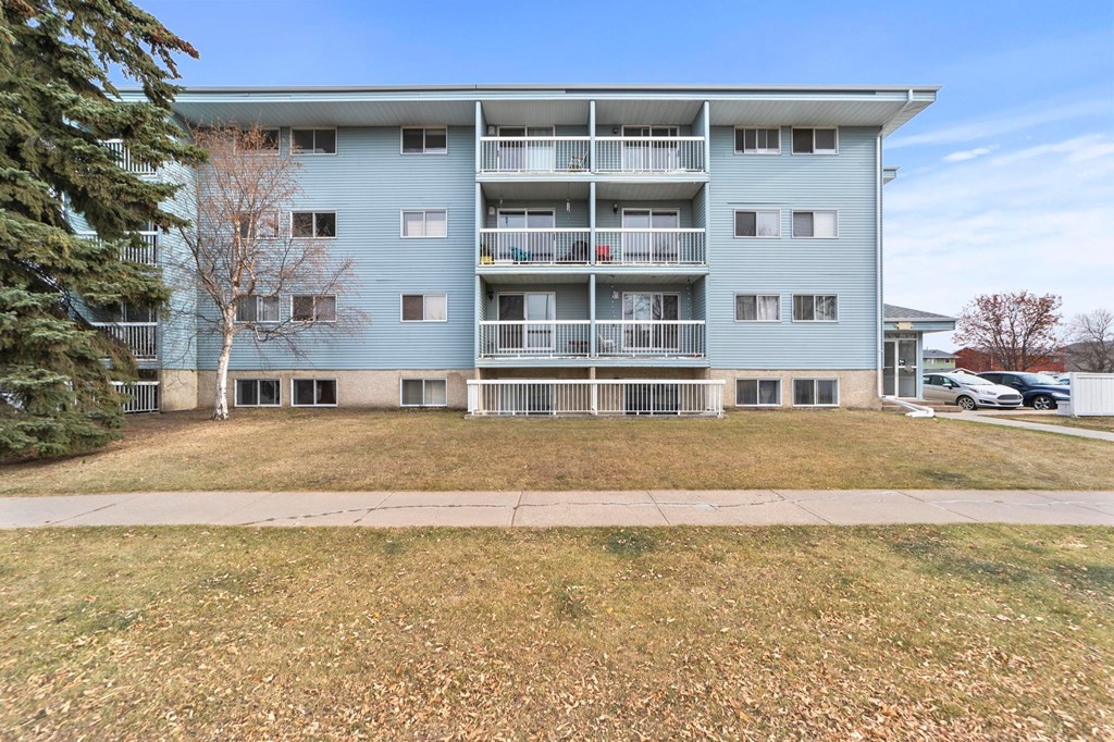 A large apartment building with a balcony on the second floor.