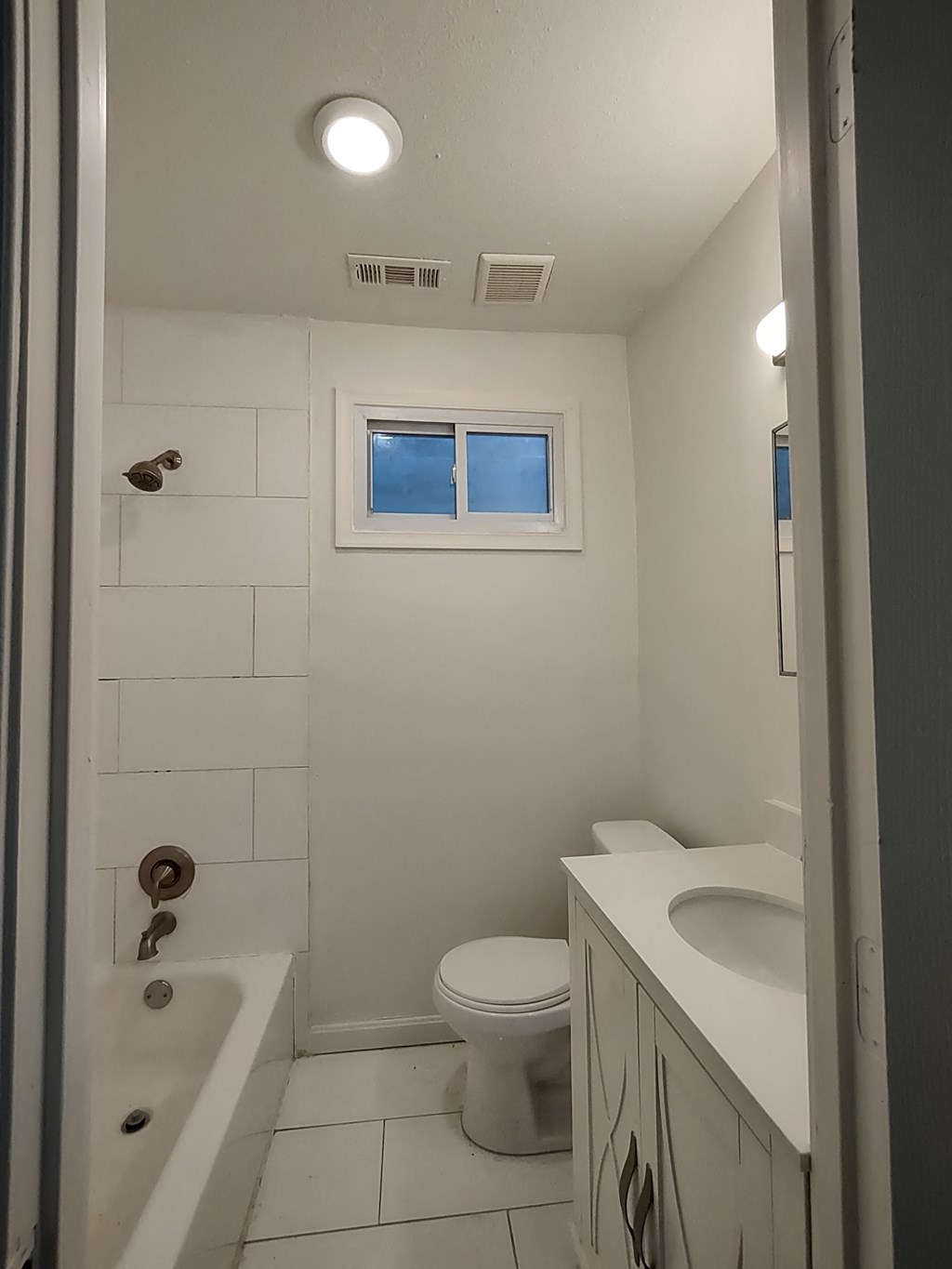 a bathroom with a toilet and a tub and a sink