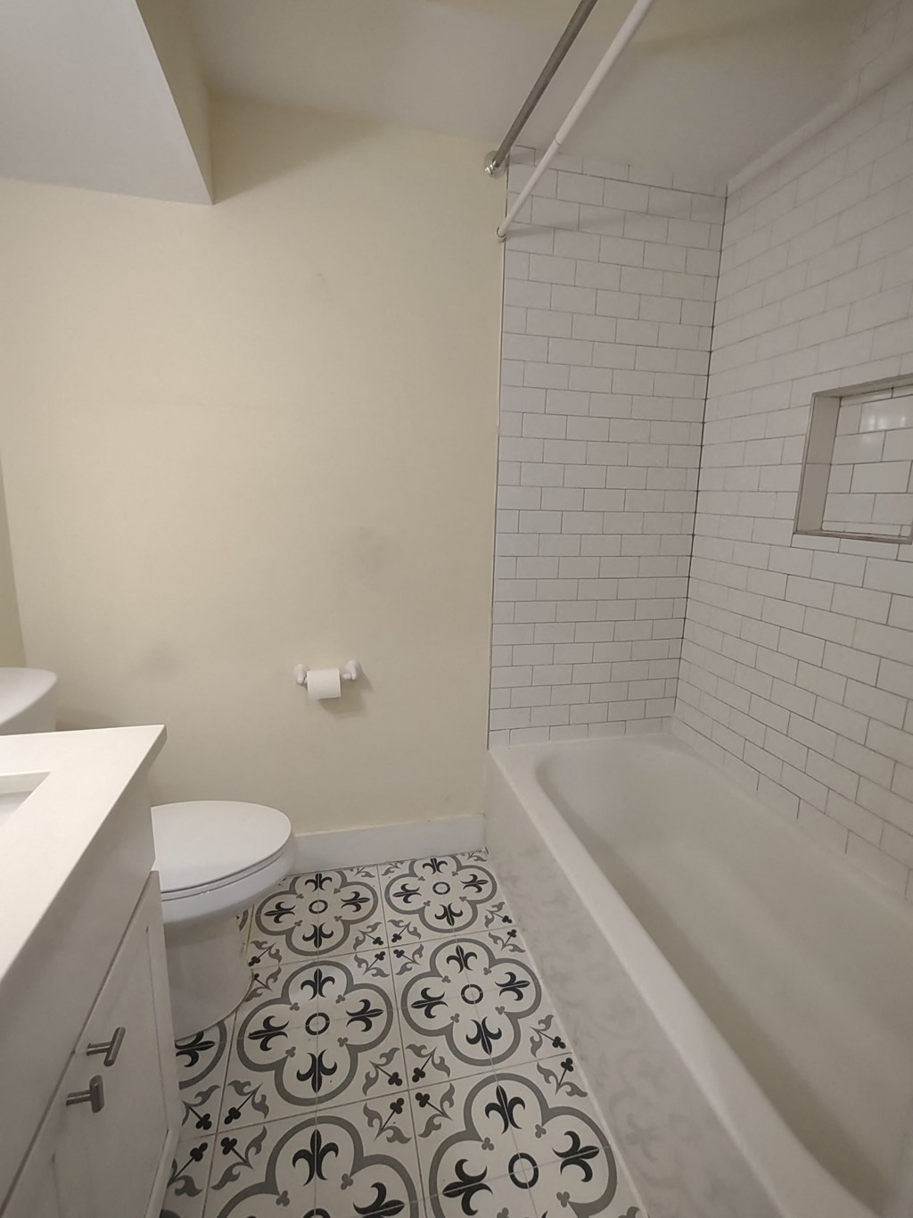 a white bathroom with a tub and a sink and a toilet