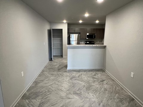a kitchen with a white counter top and a refrigerator and