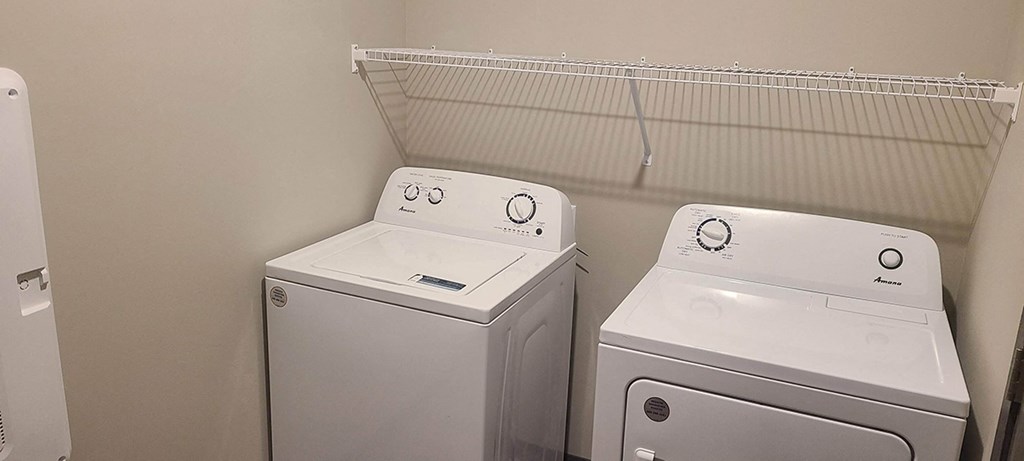 a laundry room with two washes and a dryer