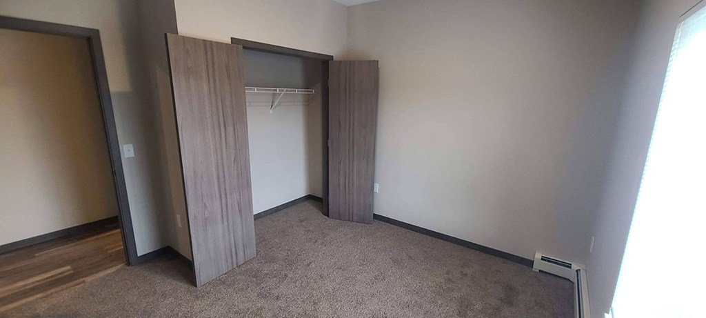 a room with a closet and a door to a wardrobe