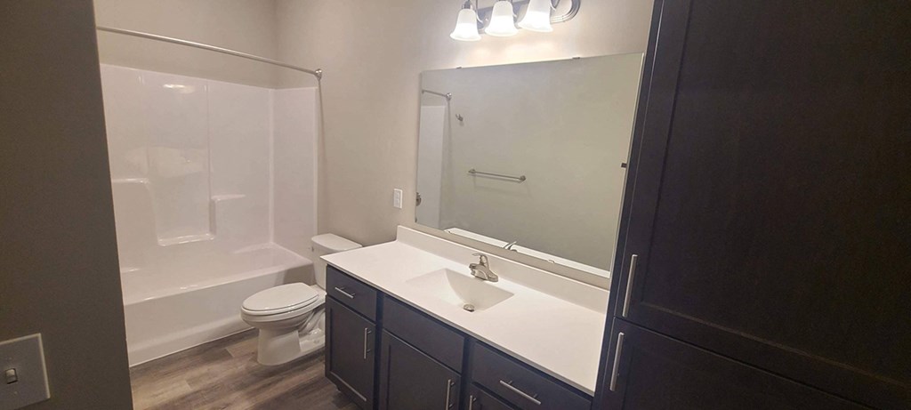 a bathroom with a sink toilet and a mirror