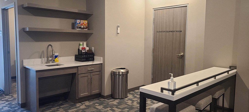 a small bathroom with a sink and a counter in a hotel room