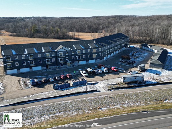 an aerial view of a large building with cars in front of it