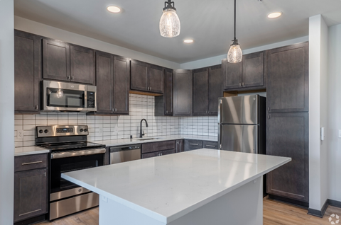 a kitchen with stainless steel appliances and a white counter top
