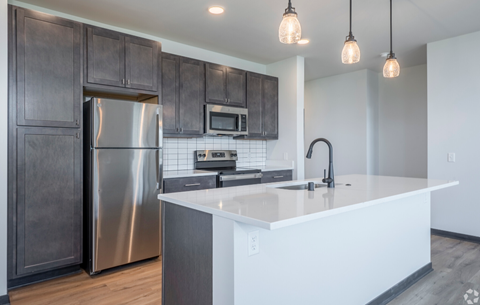 a kitchen with stainless steel appliances and a white counter top