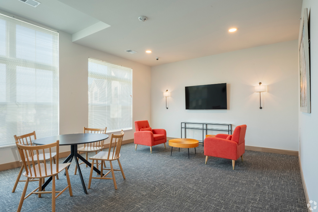 a conference room with chairs and tables and a television