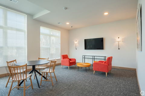 a conference room with chairs and tables and a television