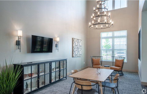 a dining room with a table and chairs and a tv