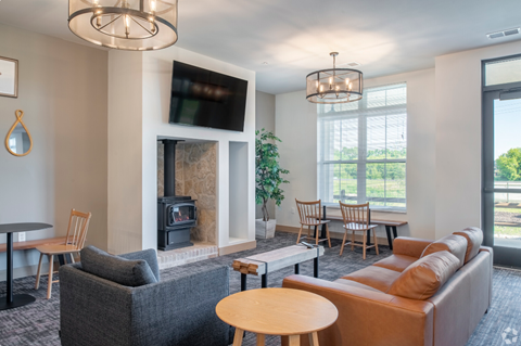 a living room with a couch and tables and a fire place