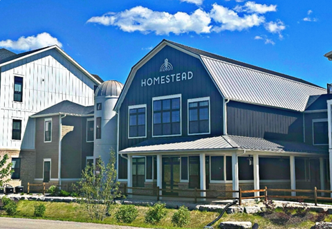 the front of the homestead building on a sunny day