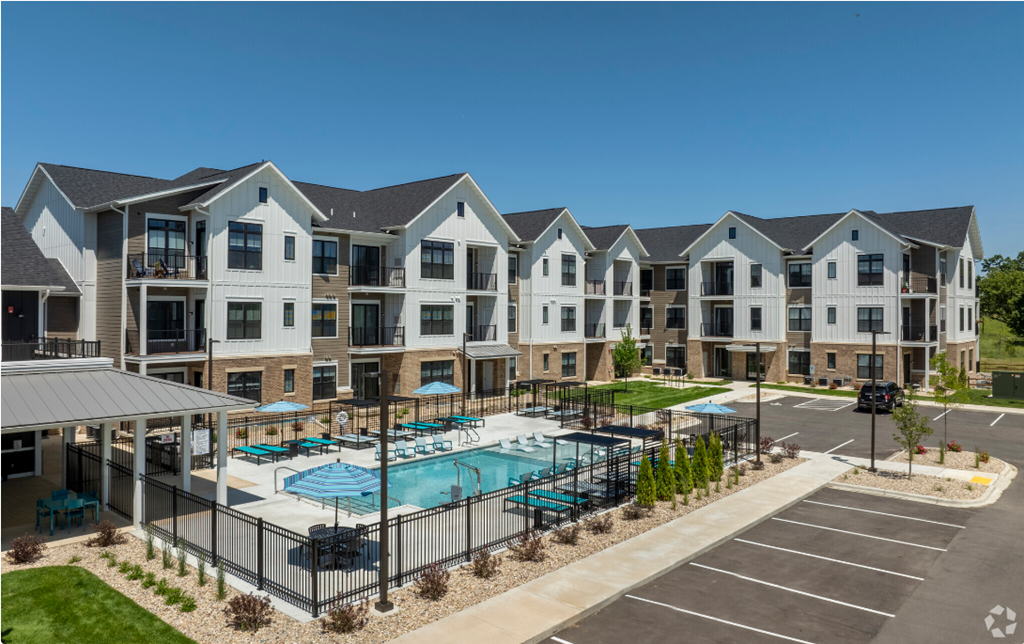 an image of an apartment building with a swimming pool