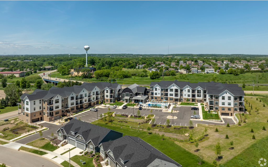 an aerial view of an apartment complex with a water tower in the background