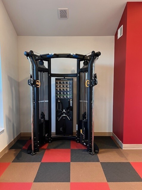 a gym room with a red and white checkered floor
