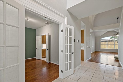 A room with white doors and a green wall.