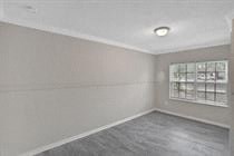 an empty room with white walls and a window