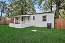 a small white house in a backyard with green grass