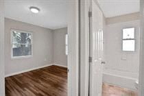 an empty room with white walls and a wooden floor