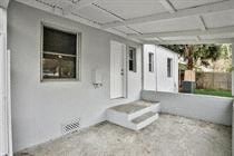 an empty garage with a porch and a door