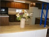 a vase with flowers on a counter in a kitchen