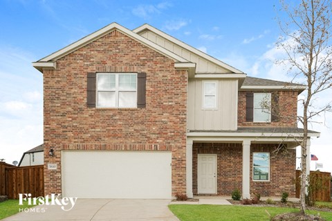a brick house with a white garage door