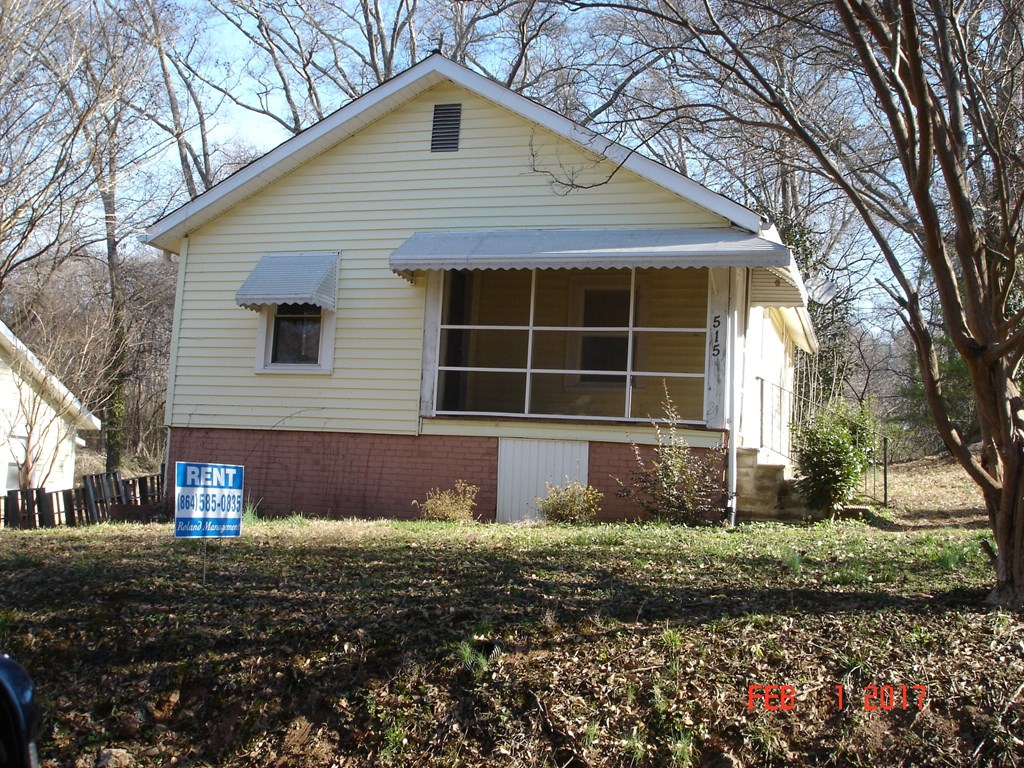 a house with a for sale sign in front of it