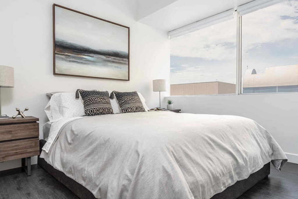 a bedroom with a large bed and a large window