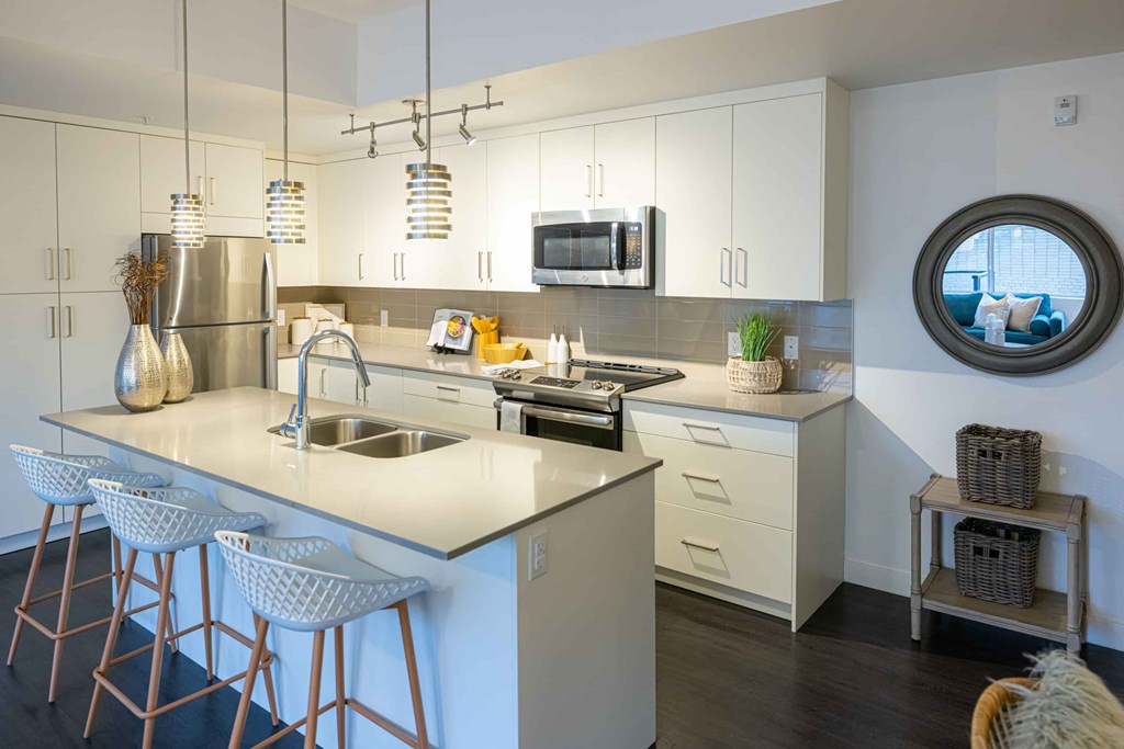 a kitchen with white cabinets and a counter top