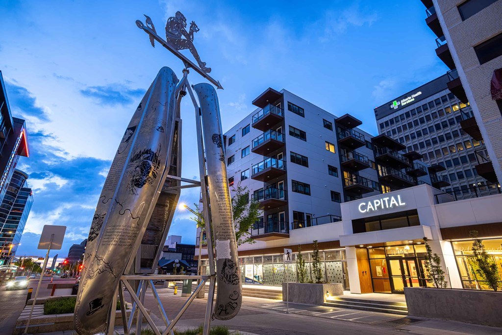a sculpture of a person on a skateboard in front of a building
