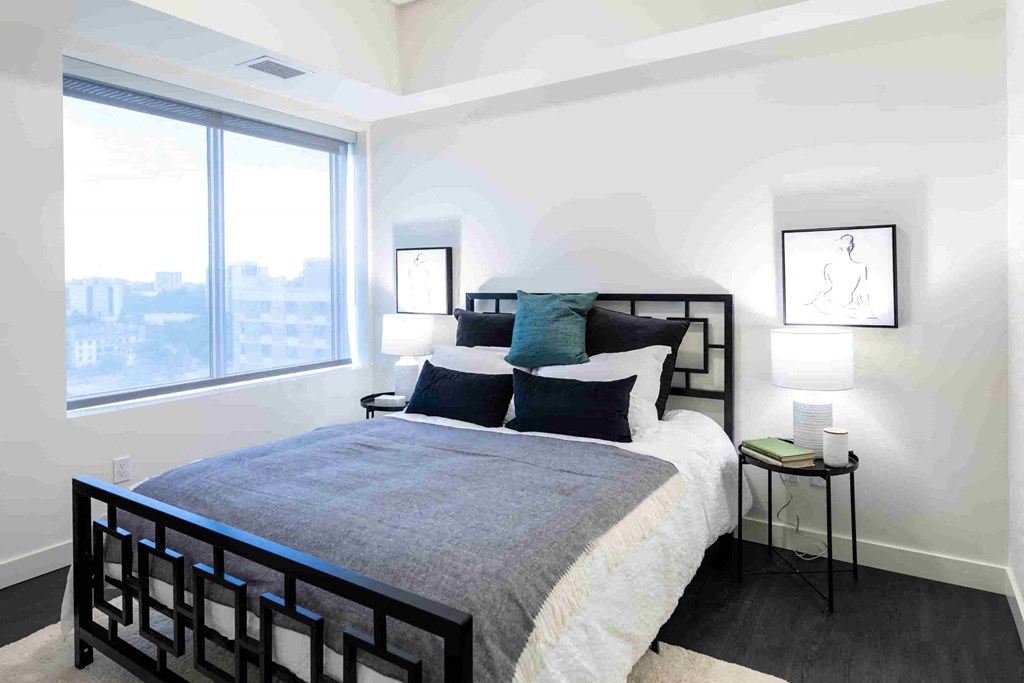 a bedroom with a bed and a window