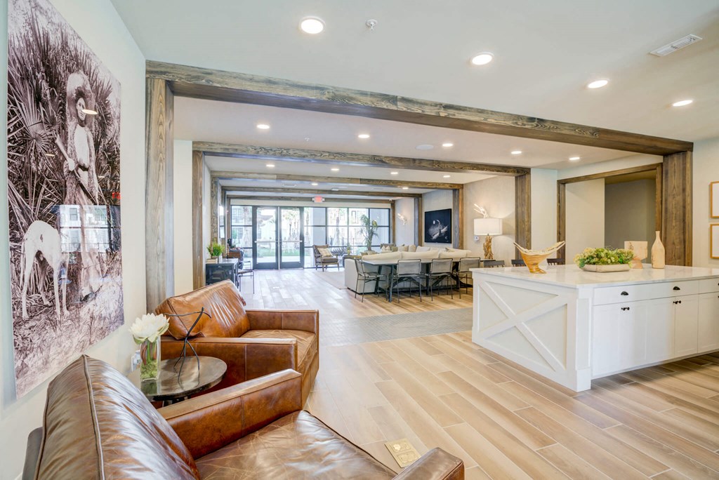 a living room with couches and a table and a kitchen
