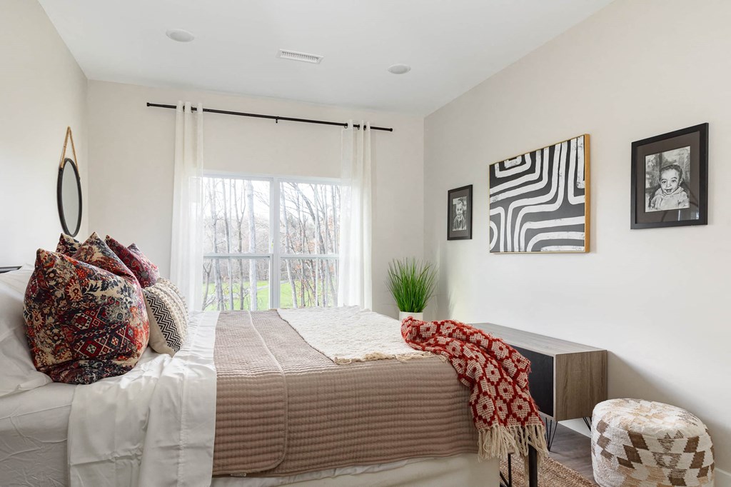 a bedroom with a bed and a window