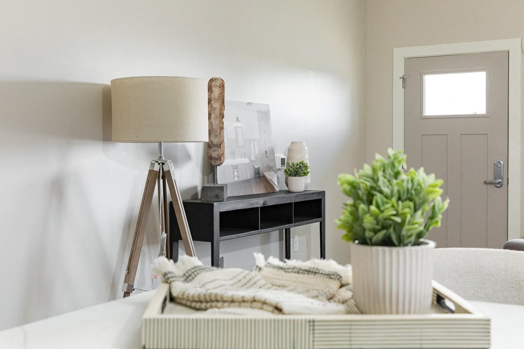 a living room with a desk and a lamp     and a couch