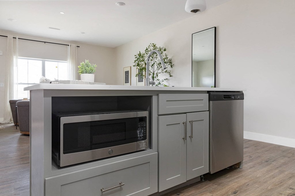 a kitchen with a microwave and a counter top
