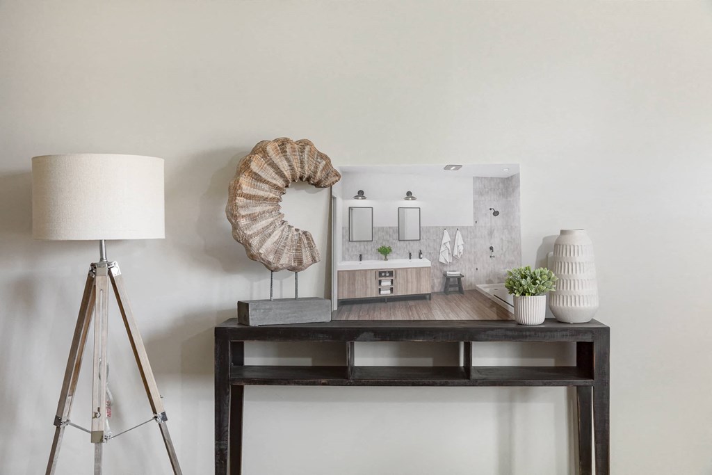 a living room with a table and a mirror