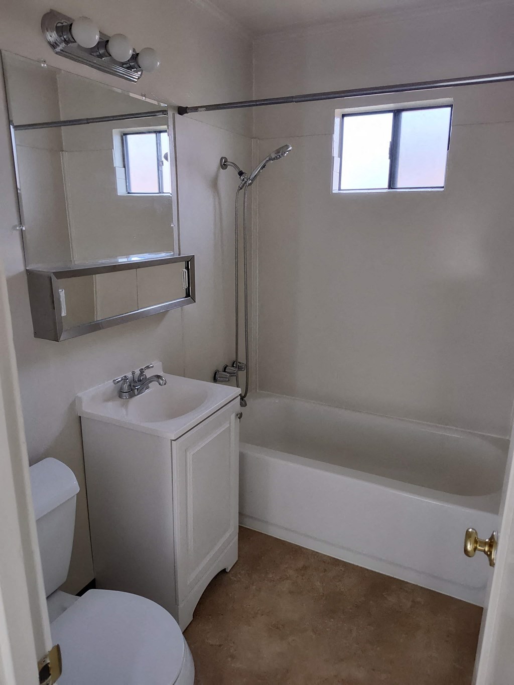 a small bathroom with a toilet and a tub and a sink