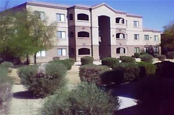 a building with a lot of bushes in front of it