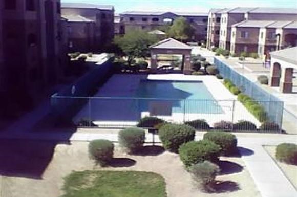 an aerial view of a swimming pool with a fence around it