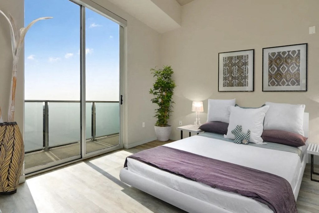 a bedroom with a bed and a view of the ocean