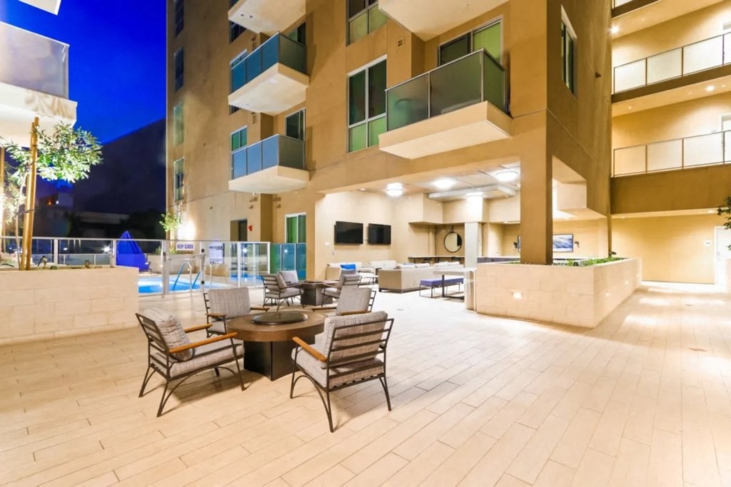 the lobby of a hotel with tables and chairs