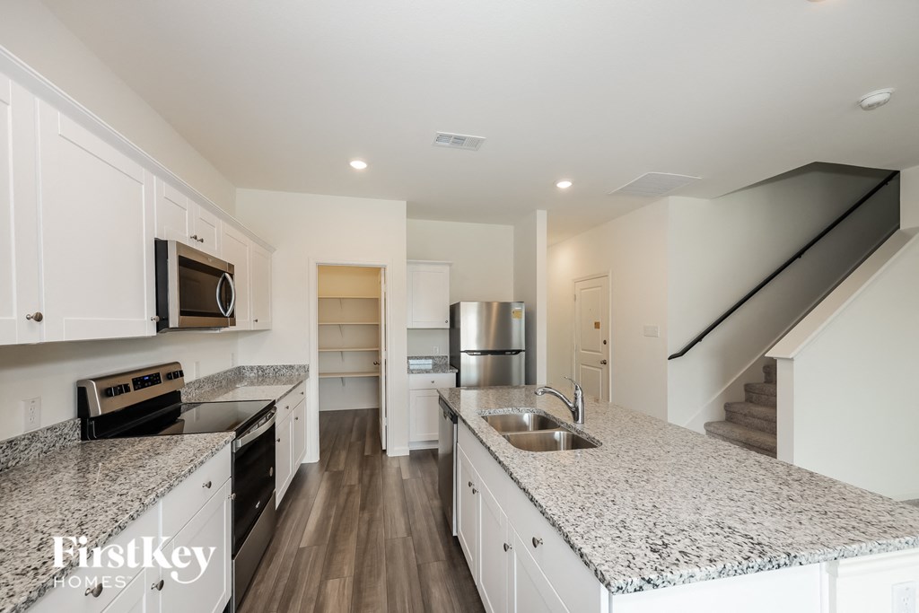 a kitchen with granite counter tops and stainless steel appliances